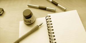 Young gorgeous business woman at desk looking into camera-[iStock_000006663074Large]